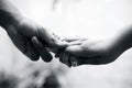 Female childÃ¢â¬â¢s hand holding the hand of elder male shot with a bokeh background and horizontal.